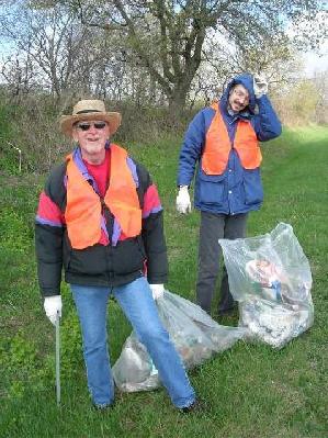 Al and Joe in spring coats, with bags of trash collected in April 2006.